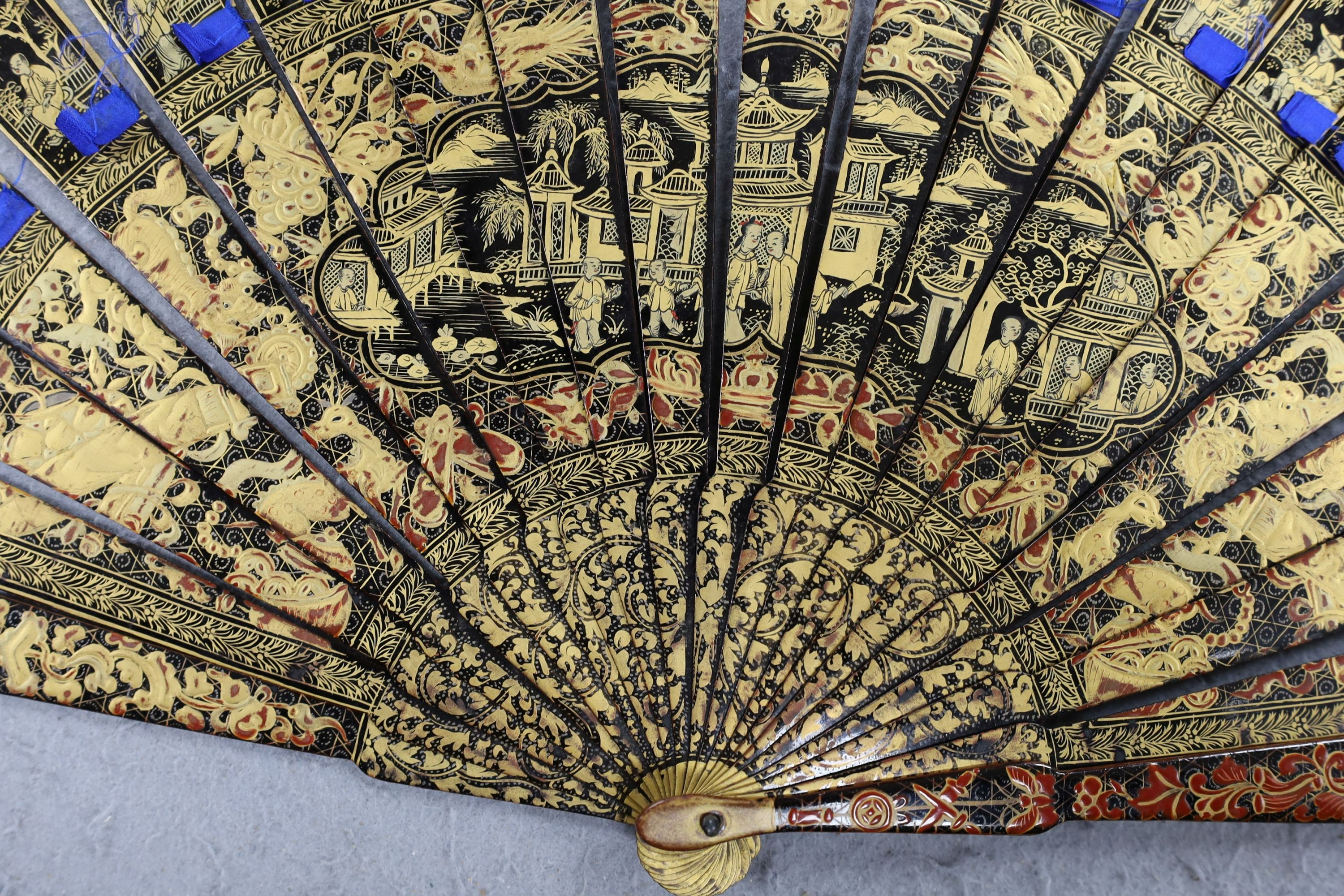 A Chinese gilt-decorated lacquer fan in a brocade covered case, 19th century